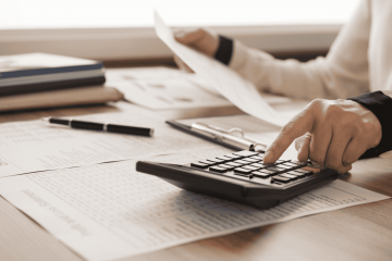 pessoa usando calculadora para representar planejamento financeiro antes de solicitar crédito